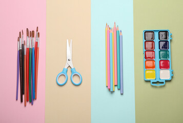 Accessories for children's creativity and education on a colored pastel background. Top view. Flat...
