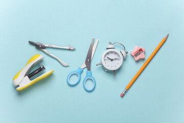 School stationery on blue pastel background. Top view. Flat lay