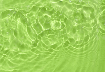Green water surface with rings and ripples. Spa concept background.