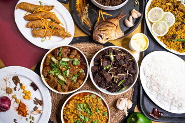Assorted indian food Loitta Fry Fish, Fried Pomfret, Jhura Bhuna, Indian Shredded Beef, kala bhuna, mezbani Gosht, dala chana, yakhni biryani, plain rice, chicken rezala, stir fry Mix Vegetables,