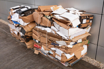 Cardboard waste tied together on a pallet. - 753229671