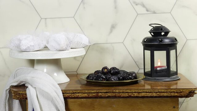 algeria cookies made from almond paste and covered with sugar powder, dates, lantern on wood tabke, happy ramadan an eid al fitre concept
