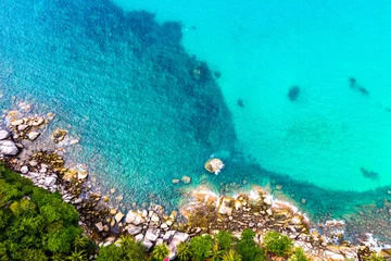 Photo sur Aluminium brossé Turquoise aerial view waves crashing on the rock beside the beach..white bubble waves in turquoise sea on the rock. .creative nature and travel concept.