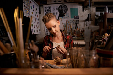 Artist, woman and tools with woodwork in workshop with craftsmanship, knife and handmade design with creativity. Wood, carpenter or creative person at workspace with equipment for handicraft or hobby