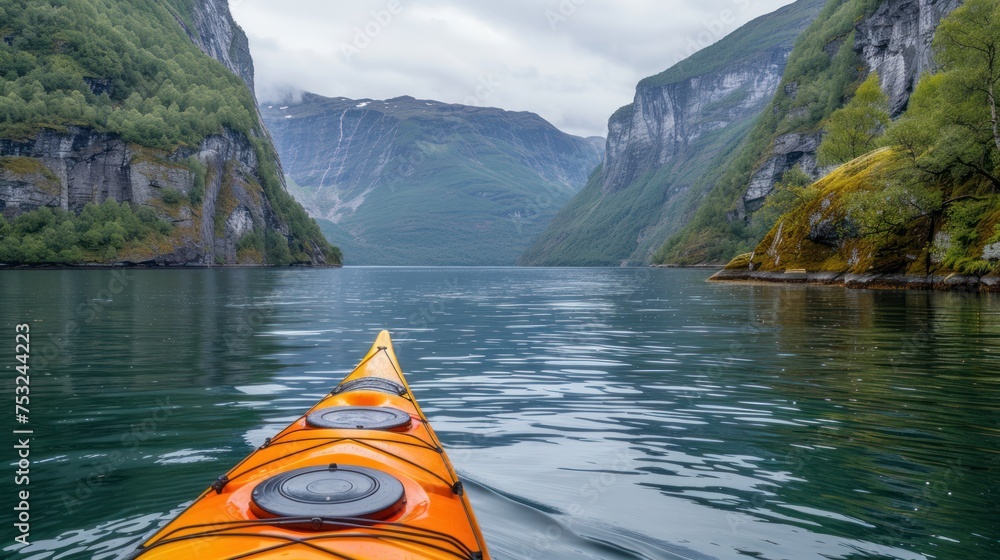 Sticker an orange kayak is in the middle of a body of water with mountains in the background and a body of w