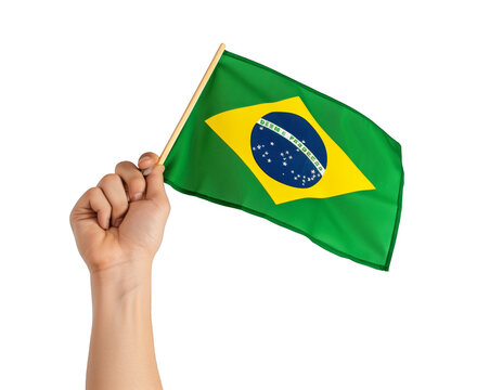 A hand holding a green flag with the word Brazil on it