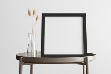 Black square frame mockup with a lagurus decoration on the beige table.