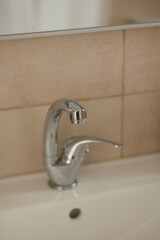 Close up shiny clean sink faucet