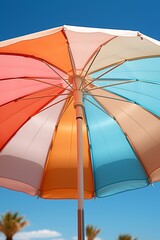Colorful Umbrella on Sunny Beach with Palm Trees
