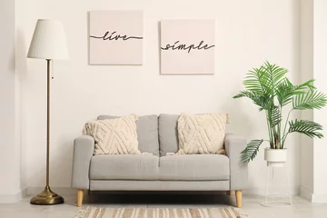 Fotobehang Lengtemeter Interior of modern living room with comfortable sofa, lamp, pictures and houseplant
