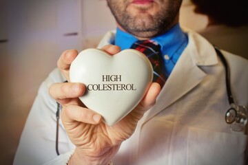 World Hypertension Day. Bearded doctor holds a white heart with text 