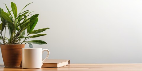 Front view of a wooden desk with a coffee mug and a houseplant, providing space for work and copying. - obrazy, fototapety, plakaty