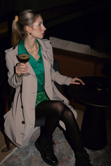Elegant rich independent Woman in green Dress up with make up in an fancy restaurant and bar over the top berlin
