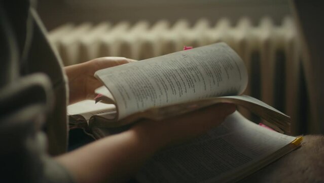 slowly flipping pages of bible in bedroom