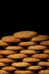crackers stacked making a foreground wall with black background space for text photo vertically