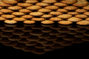 crackers stacked to make a wall, foreground wall with reflection black background and space for text