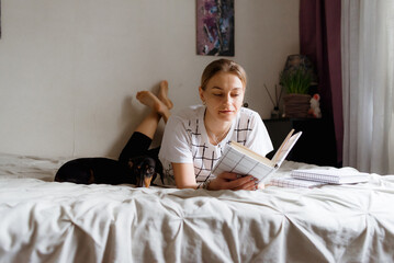 woman in bed with laptop woman reading book
