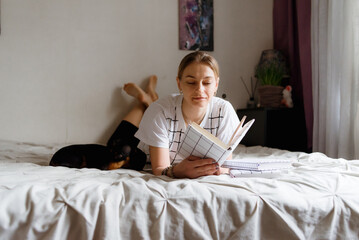 woman reading a book in bed