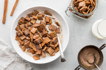 Cinnamon toast crunchy cereal in a bowl with fresh milk.
