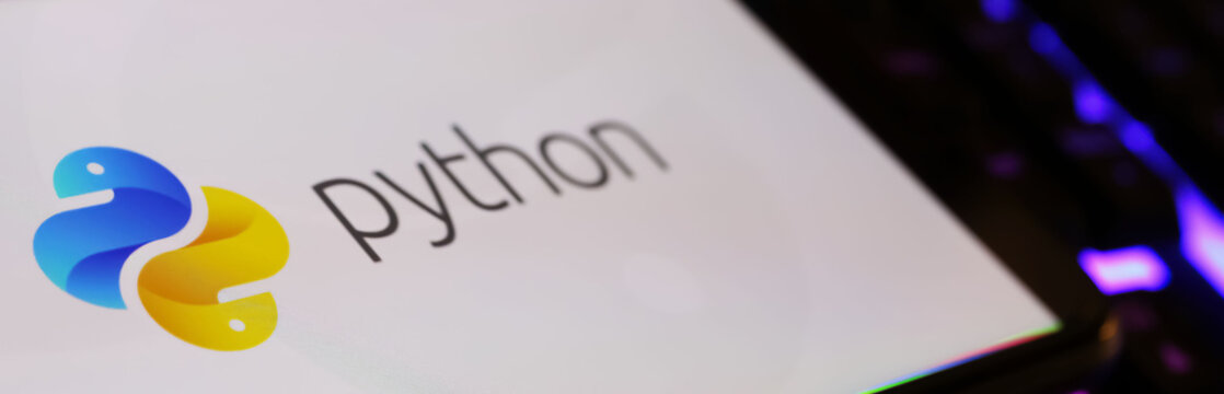 Viersen, Germany - March 1. 2024: Closeup of smartphone screen with logo lettering of Python programming language on computer keyboard
