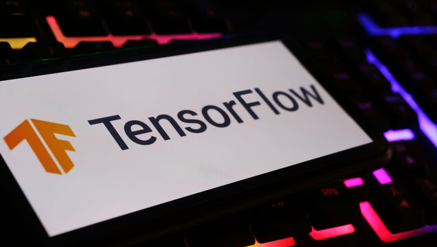 Viersen, Germany - March 1. 2024: Closeup of smartphone screen with logo lettering of TensorFlow library on computer keyboard
