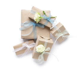 Gift boxes with beautiful roses on white background. International Women's Day