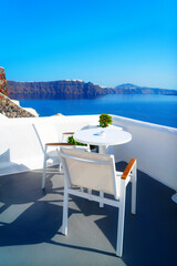 relaxing chairs and umbrella with view of caldera, Santorini, Greece