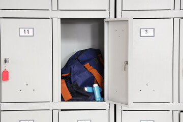 Sports bag with asthma inhalers in locker at gym