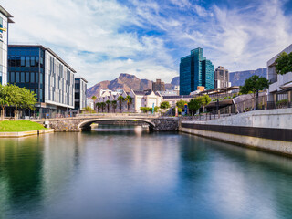 V and A Waterfront's canal and Cape Town city with the table mountain in the background, Cape Town,...