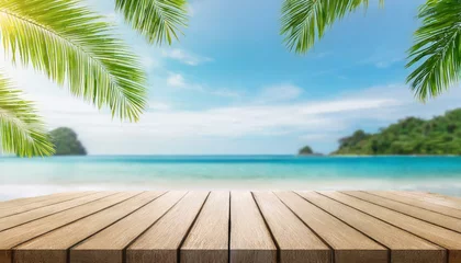 Foto auf Alu-Dibond wood table with seascape and palm leaves, blur bokeh light of calm sea and sky at tropical beach background © Marko