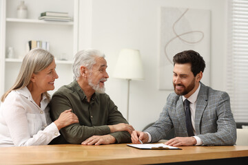 Notary consulting senior couple about Last Will and Testament in office