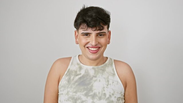 Cheerful young man wearing flattering sleeveless t shirt, playfully winking at the camera, flashing a happy face against an isolated white backdrop. a fun, sexy expression from this happy guy!