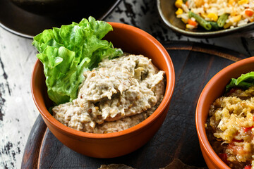 Eggplant caviar in bowl on wooden background. Vegan snack food, top view