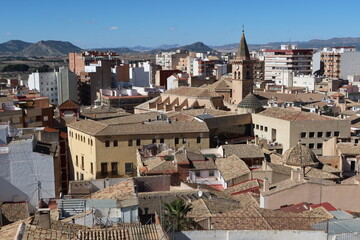 Villena, Alicante, Spain, March 5, 2024: Houses around the Church of Santiago Apostol with...
