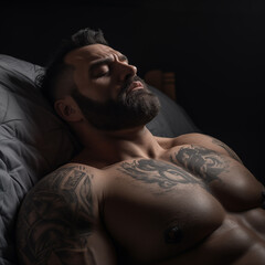 a muscular guy with a beard and tattoos lies on his back in bed and sleeps