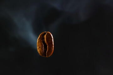 Food and drink background, Macro photo of single coffee bean flying over dark background and smoke,...
