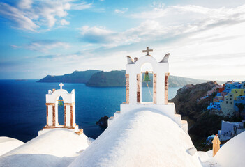 white church belfries and volcano caldera with sea landscape, beautiful details of Santorini island, Greece, retro toned - obrazy, fototapety, plakaty