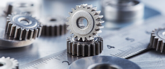 metal gears and bearings. Background with part of the mechanism.