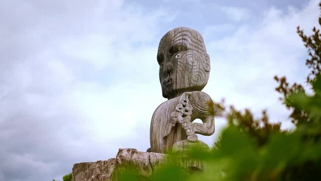 Maori statue at Wairakei Terraces in New Zealand. Silica terraces, geothermal and mineral hot pools.
