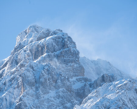 Snow-capped sunlit peak in Krnica Valley, Julian Alps on a clear winter day