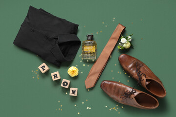 Words PROM with male shoes, shirt and perfume bottle on green background