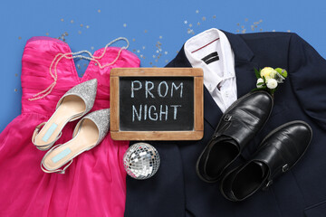 Chalkboard with text PROM NIGHT, male and female outfits on blue background