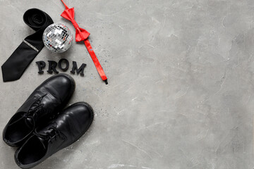 Word PROM with male shoes, tie and disco ball on grey grunge background