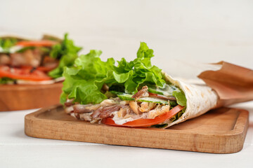 Board with tasty doner kebab on  table