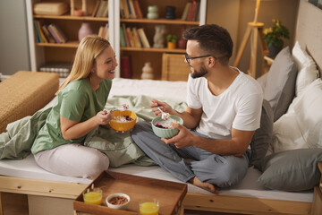Couple in love enjoying breakfast in bed