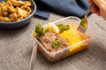 Kibe healthy packed lunch box being eaten with fork and knife in aerial view