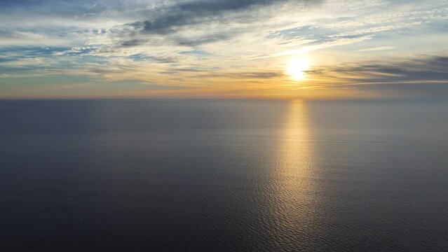 Spectacular colorful sunset over the Atlantic Ocean with solar path on the water