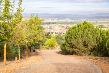 French Way of Saint James - a paved road with a view over San Justo de la Vega and Astorga, province of León, Castile and Leon, Spain