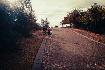 French Way of Saint James - a cyclo-touring bike .on a paved road near San Justo de la Vega, Comarca of La Vega del Tuerto, province of Leon, Castile and Leon, Spain - 753292025
