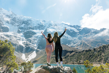 Victorious girls on top of the mountain, Humantay Lagoon, Cusco Peru